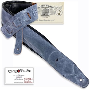 May include: A blue leather guitar strap with a distressed finish and a Walker & Williams logo. The strap has a padded shoulder section and is adjustable.