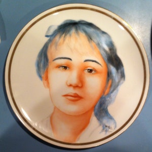 handpainted portrait of young lady with blue hair on a porcelain plate by featured artist Mitzi Soldner