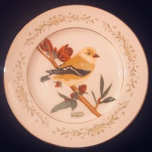 Goldfinch perched in a blossoming tree