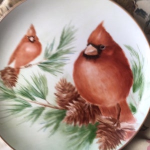 Set of three 10 1/2 inch handpainted cardinal plates.