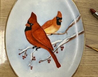 Beautiful cardinals on an oval plate