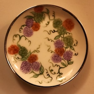 Handpainted raspberry vines coaster plate approximately 3 inches across.