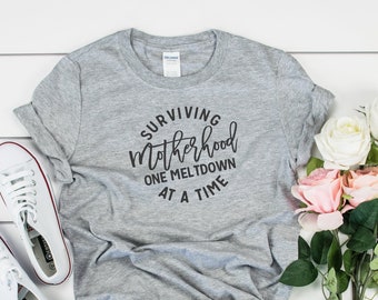 Surviving Motherhood One Meltdown At A Time Shirt, Motherhood Tee,Mom Shirt,Mom Gift,Funny Mom Shirt,New Mom Gift,Mother's Day Gift,Mommy