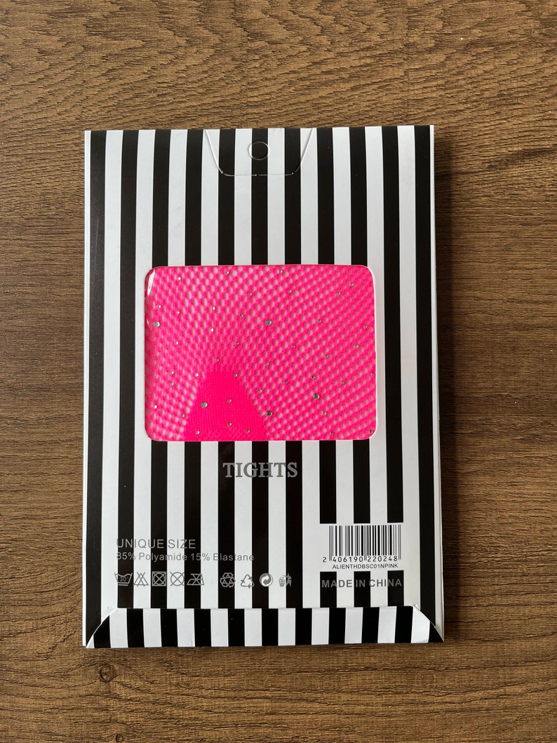 May include: Pink tights with a diamond pattern and a black and white striped packaging. The packaging includes the text "TIGHTS", "UNIQUE SIZE", "85% Polyamide 15% Elastane", and "MADE IN CHINA".