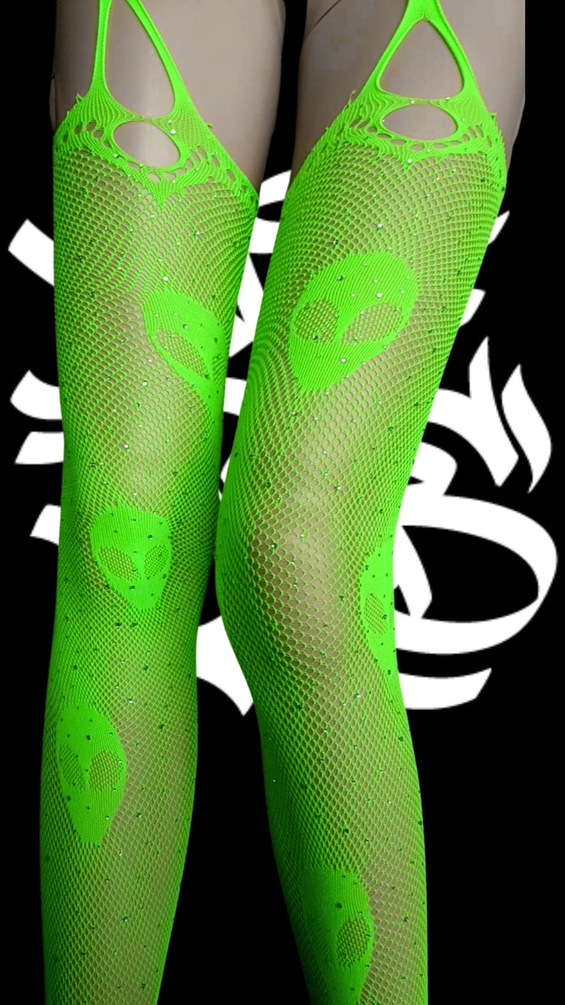 May include: Green fishnet stockings with alien head designs and rhinestones.