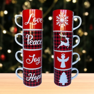 May include: A stack of red and black buffalo check Christmas mugs with white handles. Each mug has a different design: "Love", snowflake, "Peace", reindeer, "Joy", angel, and "Hope", Christmas tree.