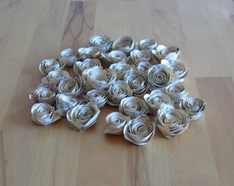 beige mini roses made from old book pages // scatter decoration // table decoration // paper blossoms // paper flowers // rolled roses
