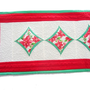 White Quilted Christmas Table Runner with Pink and Red Poinsettia Cathedral Windows Edged in Green with a Bold Red Border, 43 1/2&quot; x 13 1/2&quot;