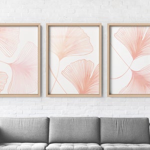 May include: Three framed prints with a white background and pink line drawings of ginkgo leaves.