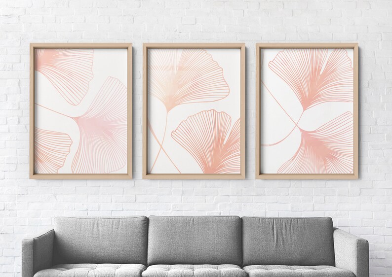 May include: Three framed prints with a white background and pink line drawings of ginkgo leaves.