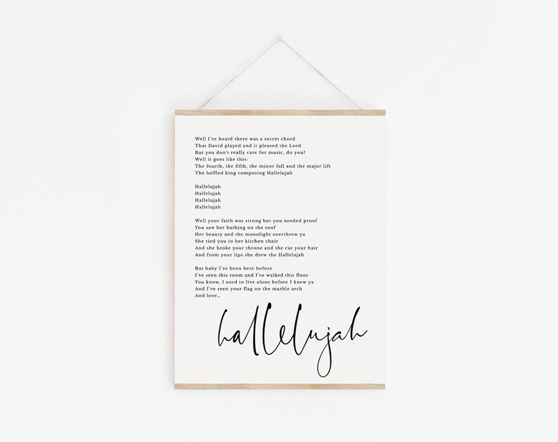 May include: Black and white printable wall art featuring the lyrics to the song "Hallelujah" by Leonard Cohen. The lyrics are printed in a simple font on a white background. The word "hallelujah" is written in a larger, more decorative font at the bottom of the page.
