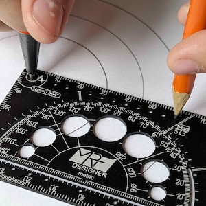 May include: A black MRF Designer metric drafting tool featuring a protractor, circular cutouts, and measurement markings. The tool displays text including 1cm=0.394, 1Rad 57.3, and various degree and millimeter labels, used here with a pencil.