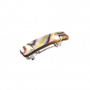 May include: A brown, white, and gold marbled hair clip with a silver metal clasp.