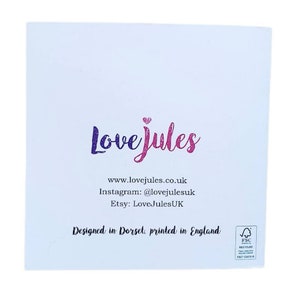 Op de afbeelding: Een witte kaart met de tekst "Love Jules" in roze en paarse letters. De kaart bevat ook het websiteadres "www.lovejules.co.uk", de Instagram-handle "@lovejulesuk", de Etsy-winkelnaam "LoveJulesUK" en de tekst "Designed in Dorset, printed in England".