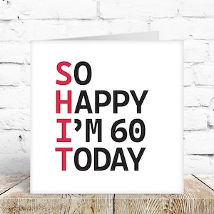 May include: A white card with black and red text that reads "SO HAPPY I'M 60 TODAY". The word "SO" is in red, and the rest of the text is in black.
