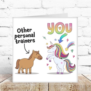 May include: A greeting card with a cartoon illustration. The card features a brown horse labelled "Other personal trainers" and a unicorn labelled "YOU." The word "YOU" is in rainbow colours. The background is white.