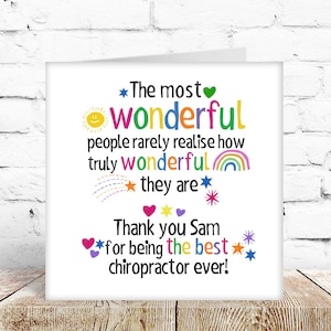 May include: A white greeting card with a message of thanks. The text says "The most wonderful people...they are. Thank you Sam for being the best chiropractor ever!" Features colorful illustrations of stars, hearts, and a rainbow.