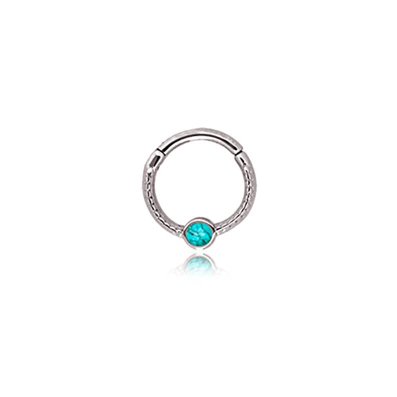 May include: A silver-colored hinged hoop earring with a textured band and a small, round, turquoise-colored stone set at the bottom. The earring is designed to be worn in a piercing.