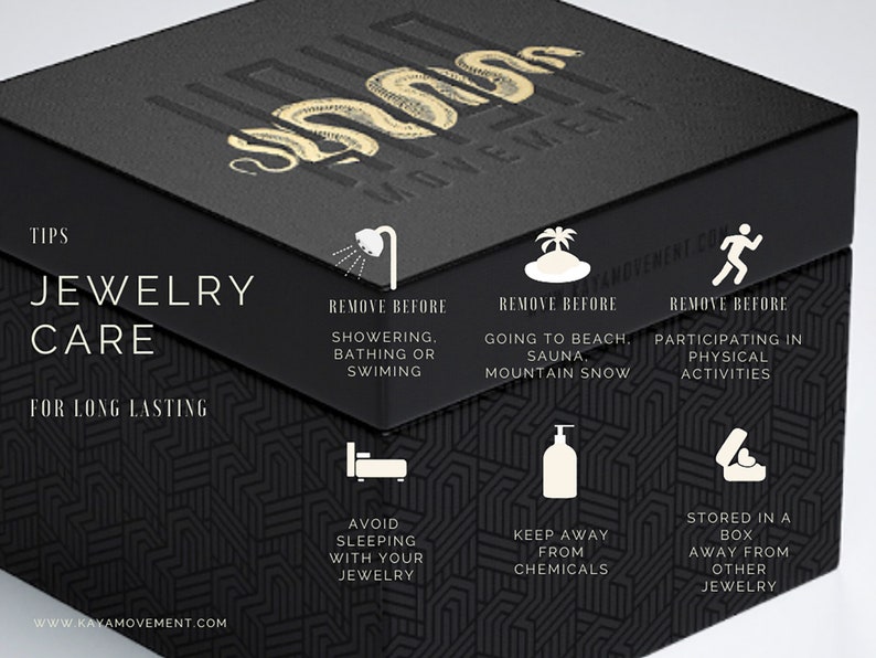 May include: Black box with gold lettering that reads "Kaya Movement". The box has a graphic of a snake and instructions for jewelry care. The instructions include removing jewelry before showering, bathing, swimming, going to the beach, sauna, mountain snow, or participating in physical activities. The instructions also include avoiding sleeping with jewelry, keeping jewelry away from chemicals, and storing jewelry in a box away from other jewelry.