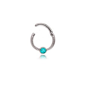 May include: A silver-colored hinged hoop earring with a textured surface. The earring features a small, round, turquoise-colored stone at the center. The earring is open, showing the hinged mechanism.