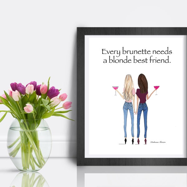 May include: A framed print with a white background and black frame. The print features a hand-drawn illustration of two women, one with blonde hair and one with brown hair, holding pink cocktails. The text "Every brunette needs a blonde best friend." is printed in black at the top of the print.