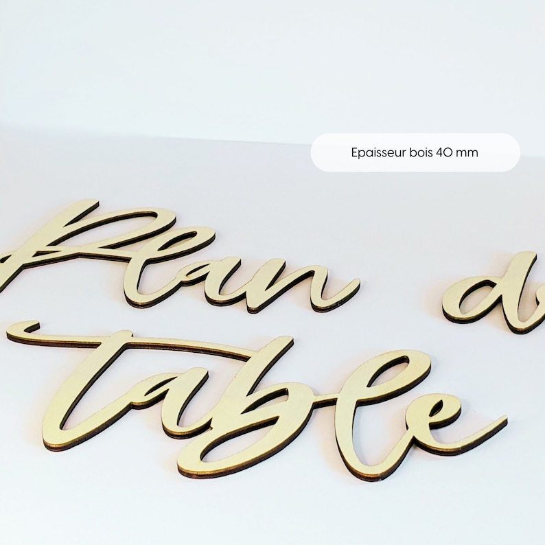 May include: Wooden sign with the words "Plan de Table" in cursive script. The sign is made of 40 mm thick wood.