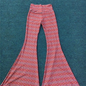May include: Red and white patterned bell bottom pants with a high waist.