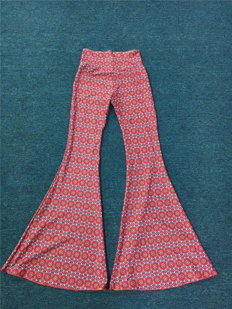 May include: Red and white patterned bell bottom pants with a high waist.