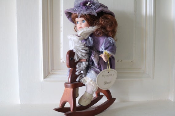 porcelain doll on rocking horse