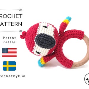 May include: Crochet pattern for a red and white parrot rattle toy. The pattern includes instructions for crocheting the parrot and attaching it to a wooden ring. The pattern is available in both English and Swedish.
