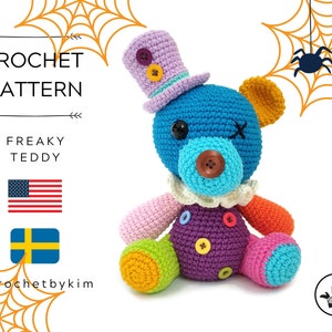 May include: A crochet pattern for a freaky teddy bear with a purple, blue, pink, orange, and yellow color scheme. The teddy bear is wearing a purple hat with a yellow button and a white ruffle collar. The pattern is available in English and Swedish.
