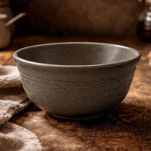 May include: A set of three ceramic nesting bowls in shades of blue, green, and white. The bowls have a speckled glaze and a simple design. The largest bowl is about 15 cm in diameter.