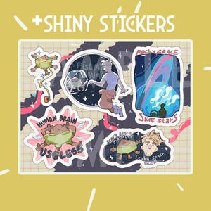 May include: A collection of five die-cut stickers featuring illustrated characters and space themes. Designs include a creature in a glass sphere, a planet with rings, a figure labeled HUMAN BRAIN USELESS, and a monster labeled SCARY SPACE MONSTER.