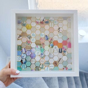 May include: A white frame containing a honeycomb pattern of colourful paper squares. The squares feature various text and designs, including the words "Mr." and "Mrs."