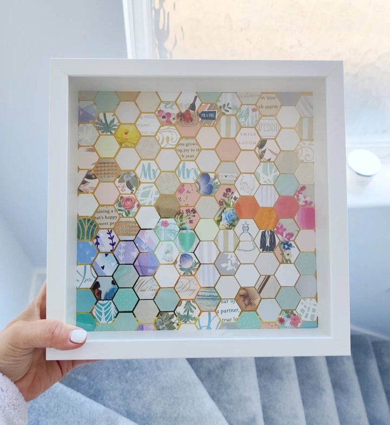 May include: A white frame containing a honeycomb pattern of colourful paper squares. The squares feature various text and designs, including the words "Mr." and "Mrs."