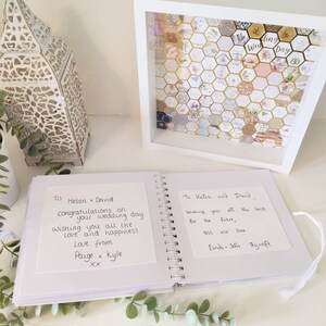 May include: A white wedding guest book with two handwritten messages. The first message says "To Helen & David, Congratulations on your wedding day. Wishing you all the love and happiness. Love from Paige & Kyle XX". The second message says "To Helen and David, Wishing you all the best for the future, All our love, Linda-John Rycroft".