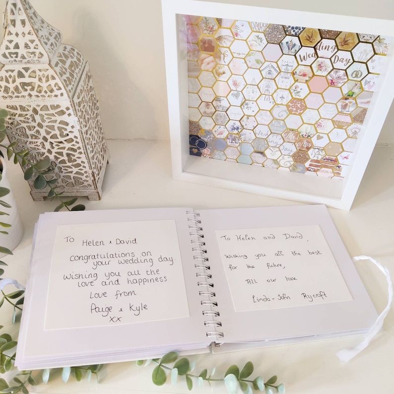 May include: A white wedding guest book with two handwritten messages. The first message says "To Helen & David, Congratulations on your wedding day. Wishing you all the love and happiness. Love from Paige & Kyle XX". The second message says "To Helen and David, Wishing you all the best for the future, All our love, Linda-John Rycroft".
