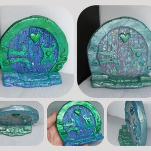 May include: A small, blue and green fairy door with a heart-shaped window and a green and blue stone base.