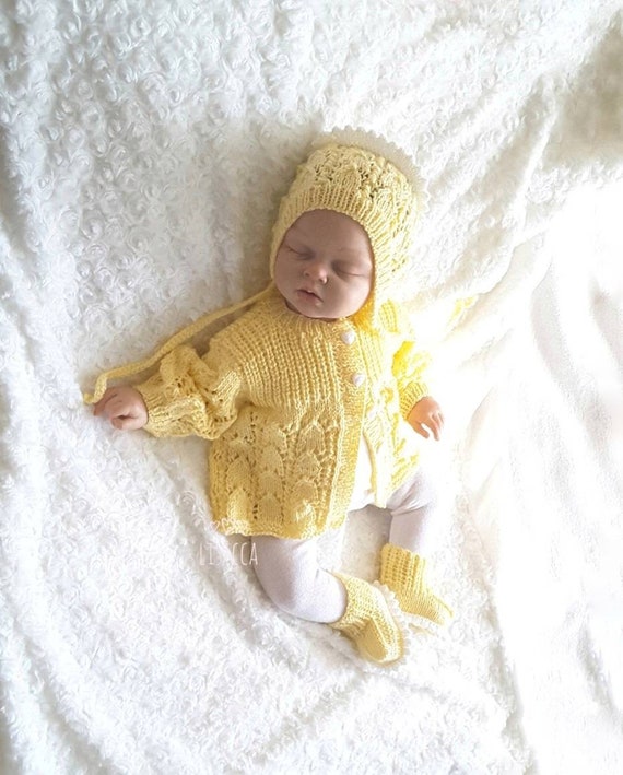 yellow knitted baby outfit