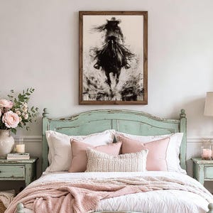 May include: A framed wall art print featuring a black and white ink-style illustration of a person riding a horse at a gallop. The artwork displays a dynamic, splattered effect and includes the text WILDWESTRO in the lower right corner.