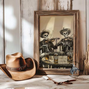 May include: A framed print depicts two skeleton cowboys playing violins at a table with whiskey bottles and glasses. A brown cowboy hat with a decorative band sits in the foreground. The artwork is in a rustic style.