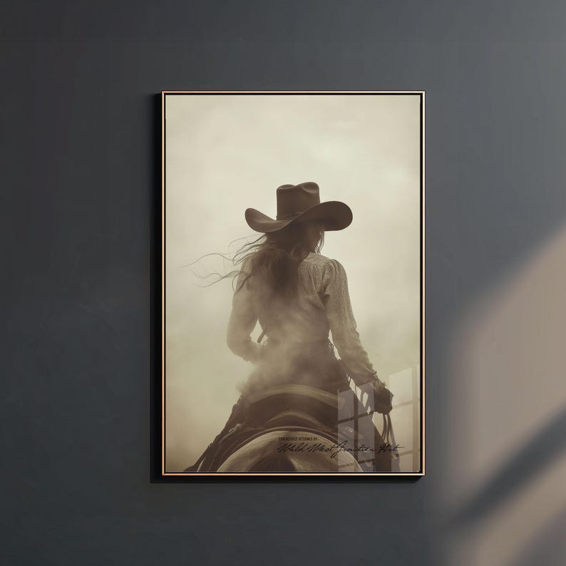 May include: A sepia-toned wall art print featuring a person wearing a cowboy hat and long-sleeved shirt, riding a horse from a rear perspective. The image has a hazy, atmospheric quality with visible text at the bottom reading Wild West Cowboy Hat.