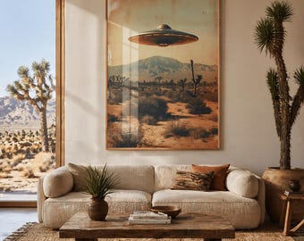 May include: A framed print showcases a desert scene with a UFO above. The artwork, in warm hues, features Joshua trees and mountains under a hazy sky. The print hangs above a beige sofa, with a wooden coffee table and a woven rug.