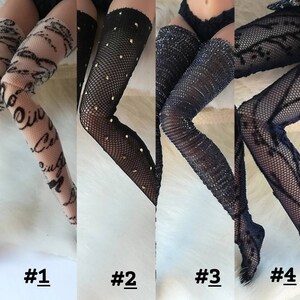 May include: Four pairs of black fishnet stockings with different patterns. The first pair has a white script pattern, the second pair has gold dots, the third pair has a sparkly finish, and the fourth pair has a floral pattern.