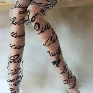 May include: White fishnet stockings with a black script pattern.