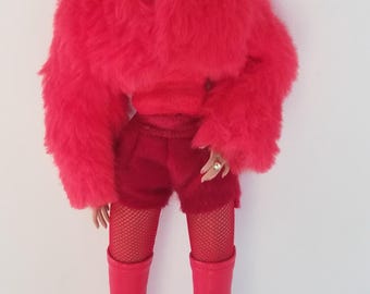 May include: A fashion doll wearing a red outfit. The doll has blonde hair and is wearing a red faux fur jacket, shorts, fishnet stockings, and thigh-high boots. Red earrings complete the look.