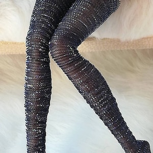 May include: Black thigh-high stockings with a sparkly, textured design.