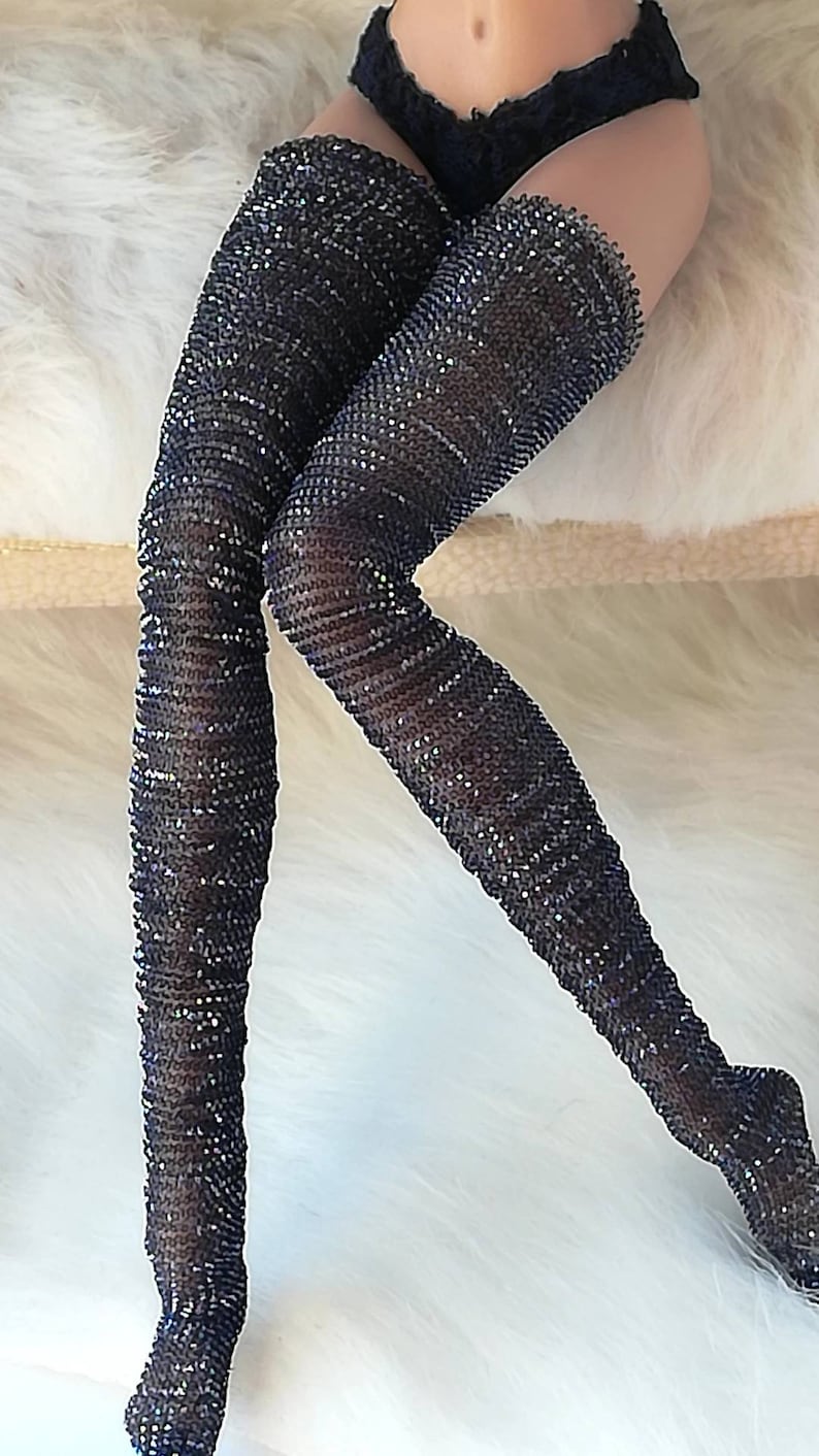 May include: Black thigh-high stockings with a sparkly, textured design.