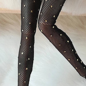 May include: Black fishnet stockings with gold glitter dots.