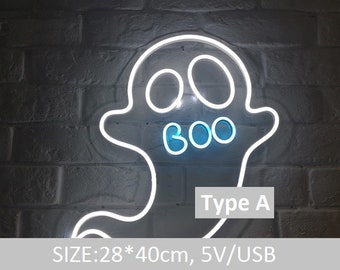 May include: A white neon ghost sign with the word "BOO" in blue neon. The sign is against a brick wall. The sign is 28cm x 40cm.